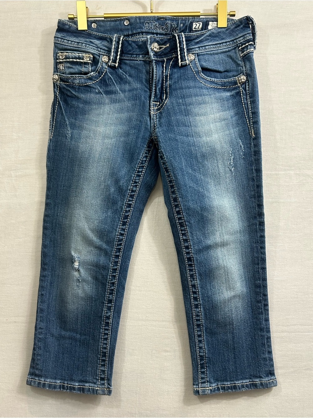 denim Miss Me capri jeans featuring sparkling rhinestone fleur-de-lis